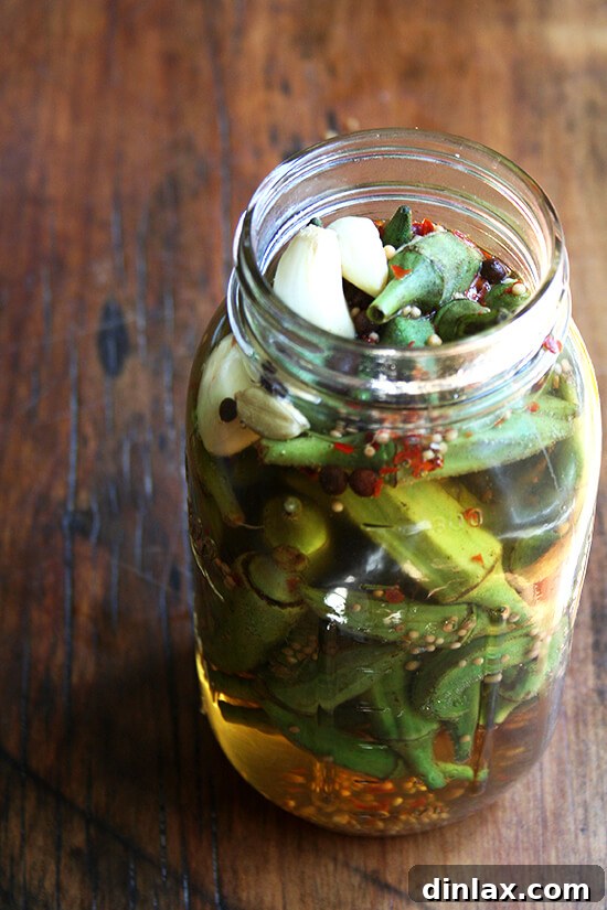 Process of pickling okra: raw okra being prepared for jarring
