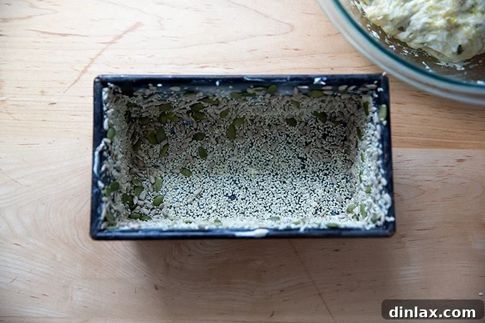Triple-Seed Stir-and-Bake Loaf 12 A standard loaf pan, thoroughly buttered and coated with a mix of seeds, ready to receive the bread dough.