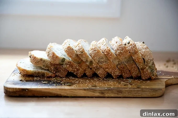 Triple-Seed Stir-and-Bake Loaf 19 A freshly sliced loaf of three-seed bread displayed on a wooden cutting board, revealing its soft interior.