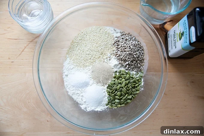 Triple-Seed Stir-and-Bake Loaf 4 A large bowl containing the dry ingredients for three-seed bread, including flour, salt, sugar, and yeast.