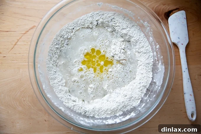 Triple-Seed Stir-and-Bake Loaf 6 A bowl filled with the dry ingredients and a spatula, as water and olive oil are added to begin forming the dough.