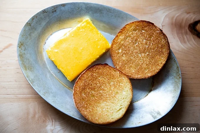 Flour Bakery's Golden Eggwich 10 Toasted brioche aside melted cheese-topped egg slice.