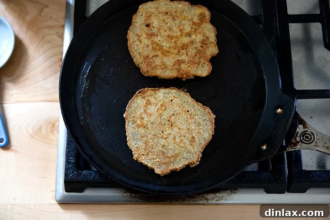 Banana-oat pancakes in a skillet.
