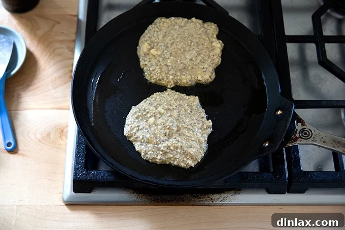Banana-oat pancakes in a skillet.