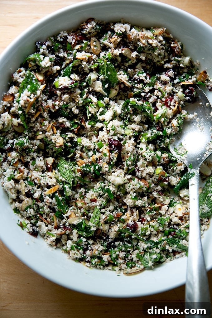 A freshly mixed bowl of cauliflower couscous salad, ready to be served.