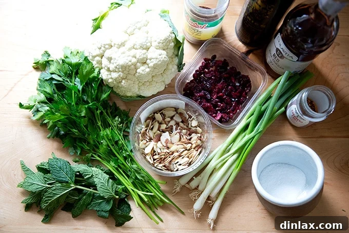 A selection of fresh ingredients laid out on a kitchen counter, ready for making cauliflower couscous salad.