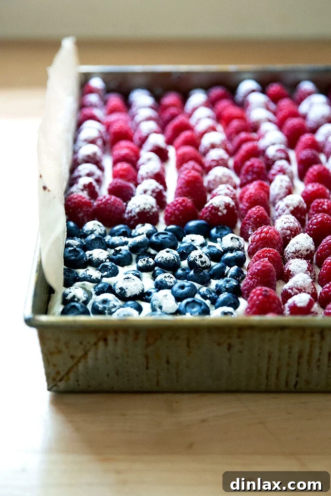 Effortless Star-Spangled Sheet Cake 16 A perfectly baked and decorated American flag cake, showcasing vibrant berries arranged in a patriotic design, ready for celebration.