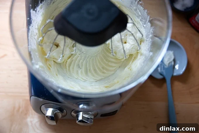 Light and Fluffy Cream Cheese Frosting 5 Cream cheese and sugar beaten together in a stand mixer.