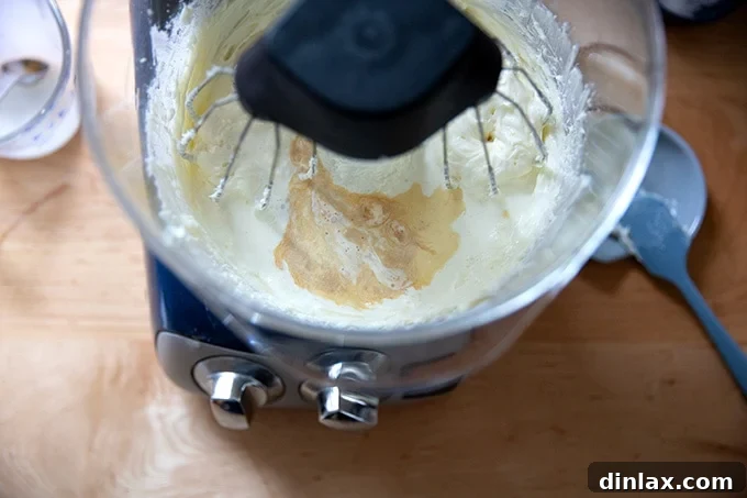 Light and Fluffy Cream Cheese Frosting 6 Adding the vanilla and heavy cream to the stand mixer.