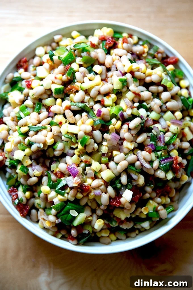A vibrant and fresh white bean salad in a stylish serving bowl, ready to be enjoyed.