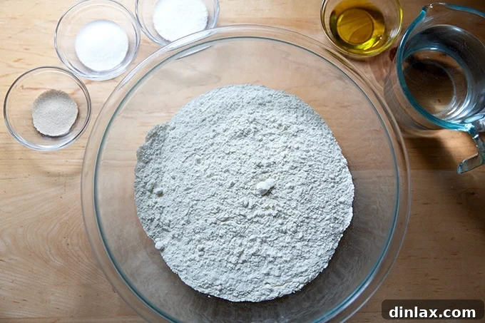 Ingredients for making homemade pretzel rolls laid out on a kitchen counter.