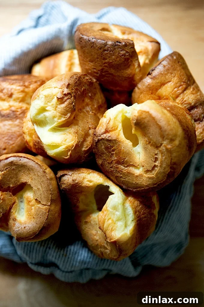 A bowl filled with freshly baked, golden popovers, ready to be served.
