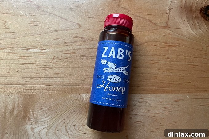 A bottle of Zab's Hot Honey, a gourmet sweet and spicy condiment