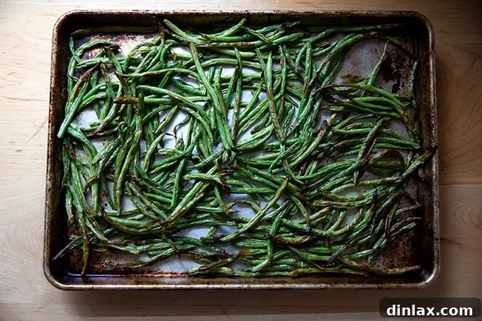 Golden Roasted Green Beans with Sweet Shallot Glaze 16 Roasted green beans on a sheet pan.