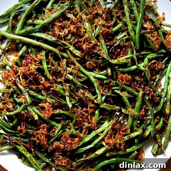 A platter of roasted green beans with crispy fried shallots.