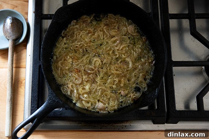 Golden Roasted Green Beans with Sweet Shallot Glaze 9 Shallots sizzling in a cast iron skillet on the stovetop.