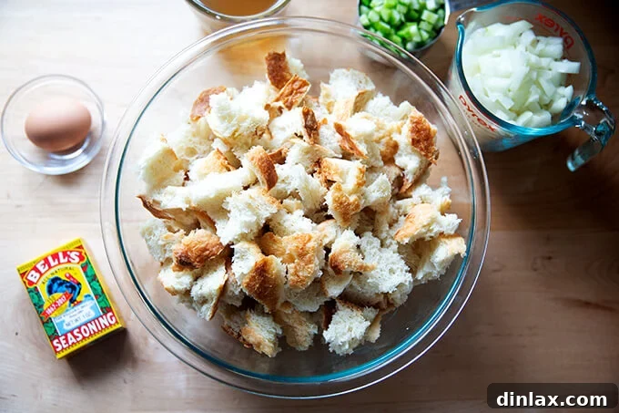 A bowl of cubed bread and ingredients to make a classic bread stuffing.
