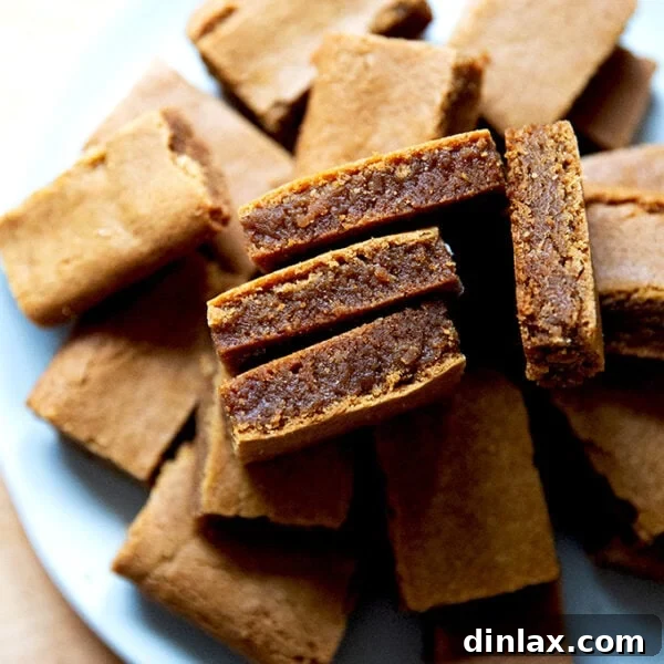 A close-up of a stack of gingerbread cookie bars on a plate.
