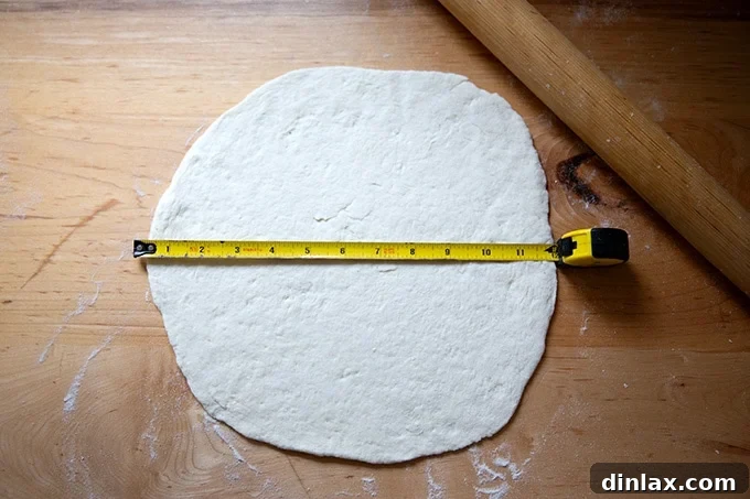 A gluten-free pizza dough round perfectly rolled out to approximately 12 inches in diameter.