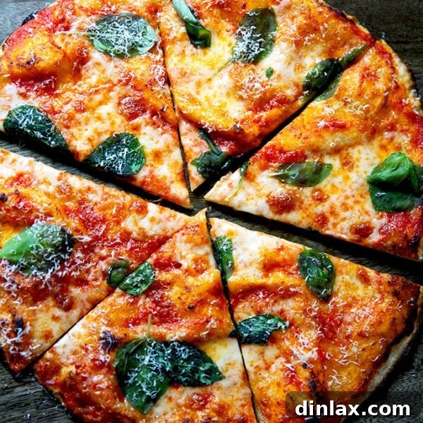 A cut gluten-free Margherita pizza on a cutting board.