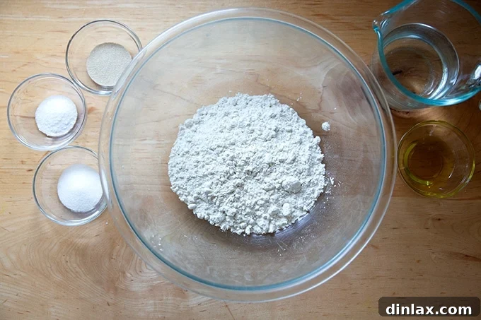 Individual ingredients for gluten-free pizza dough accurately measured on a kitchen scale on a countertop.