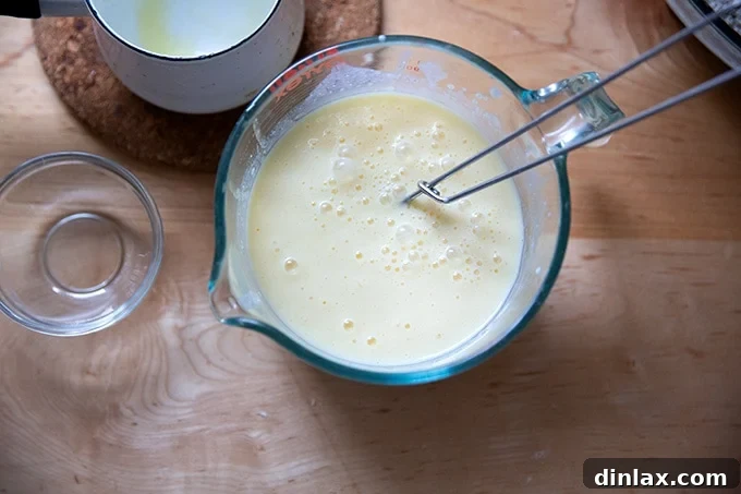 The wet ingredients for Irish brown bread, whisked together smoothly in a bowl.