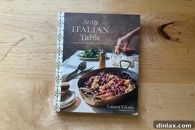 Perfect Gifts for Mom 8 Cover of 'At My Italian Table' by Laura Vitale, showcasing a spread of Italian dishes.