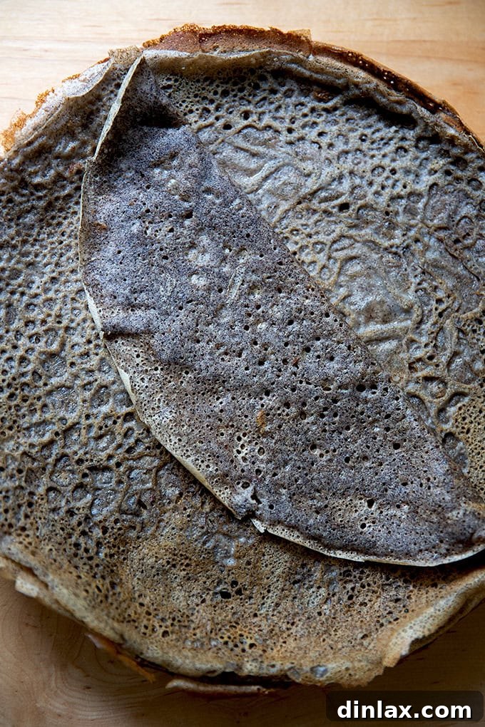 Light and Delicate Gluten Free Buckwheat Crepes 22 A stack of golden-brown cooked buckwheat crepes presented on a plate, ready for various fillings or for storage.