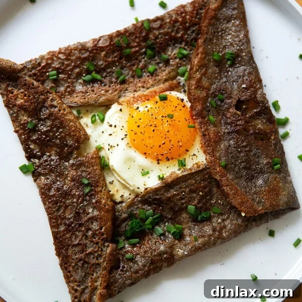A plate topped with an egg-and-gruyere filled buckwheat crepe.