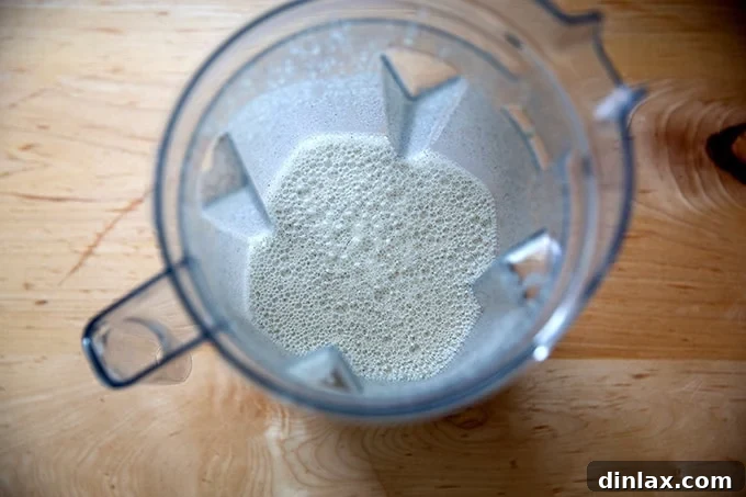 Light and Delicate Gluten Free Buckwheat Crepes 7 A blender containing smooth, frothy buckwheat crepe batter, indicating it's perfectly mixed and ready for cooking.