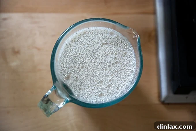Light and Delicate Gluten Free Buckwheat Crepes 8 A two-cup liquid measuring cup filled with the freshly blended buckwheat crepe batter, ready for pouring.
