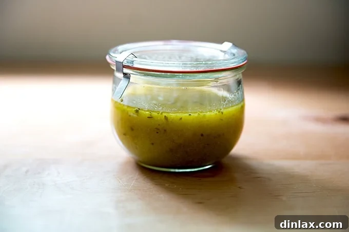 A rustic Weck jar, prominently displaying the vibrant, freshly made Italian dressing against a simple backdrop.