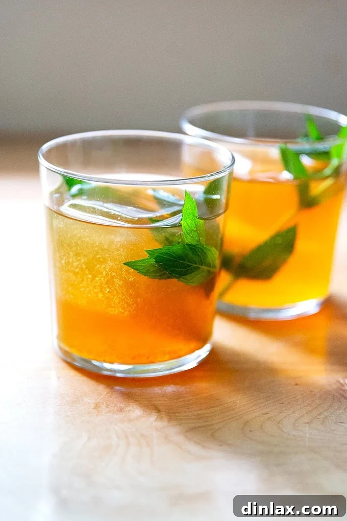Two sweating glasses of iced tea, perfectly chilled and ready for enjoyment on a hot day.