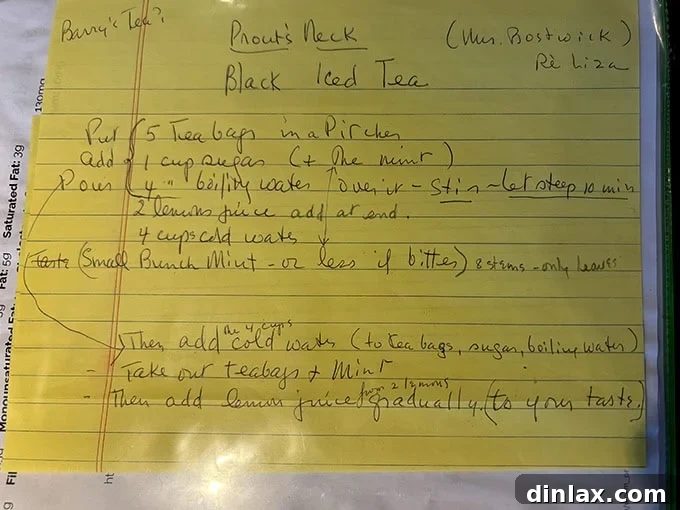 A close-up of a handwritten iced tea recipe from a vintage cookbook, showcasing elegant penmanship.