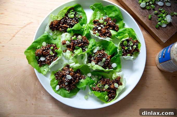 A beautifully plated dish of miso-lime tofu crumbles elegantly presented in individual lettuce cups, ready to be enjoyed.