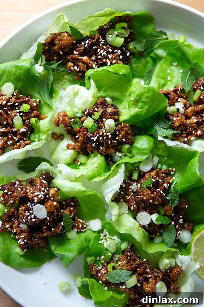 A close-up view of a full platter of crispy miso-lime tofu in lettuce cups, emphasizing its delicious appeal and vibrant presentation.