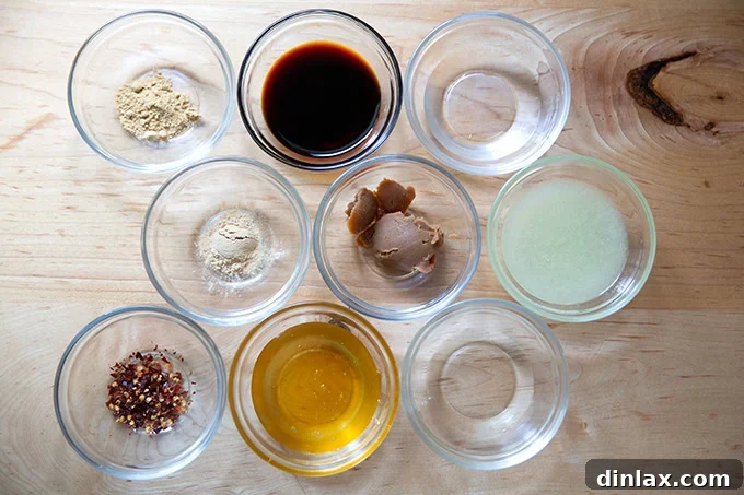 All measured ingredients for the miso lime sauce, meticulously placed in small glass bowls, ready for combining.