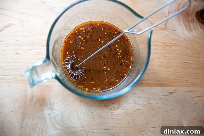 The perfectly whisked miso-lime sauce in a 4-cup measuring cup, exhibiting a smooth and uniform consistency.