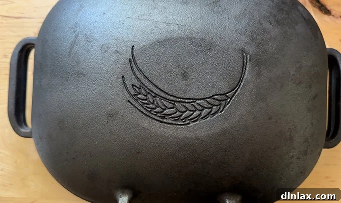 A Challenger Bread Pan with its lid securely in place, baking a baguette inside the oven.