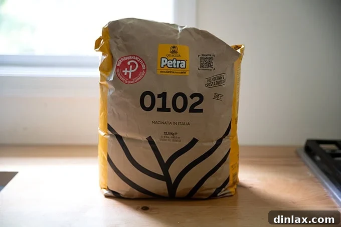 A bag of Petra 0102 flour, highlighting its specialty for bread and pizza.