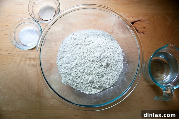 All baguette ingredients meticulously measured on a kitchen scale, ready for mixing.