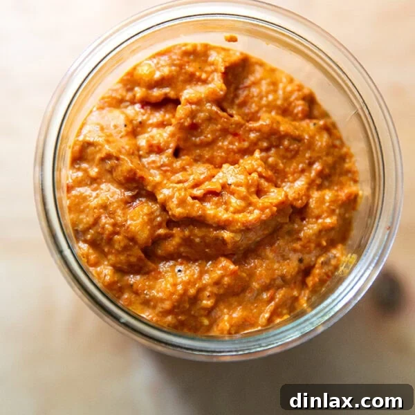 Homemade romesco sauce in a glass jar.