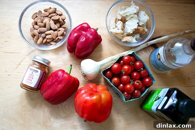 Zahmetsiz Romesco Sosu: Biberleri Soymaya Son! 4 Ingredients to make romesco sauce on a counter top.