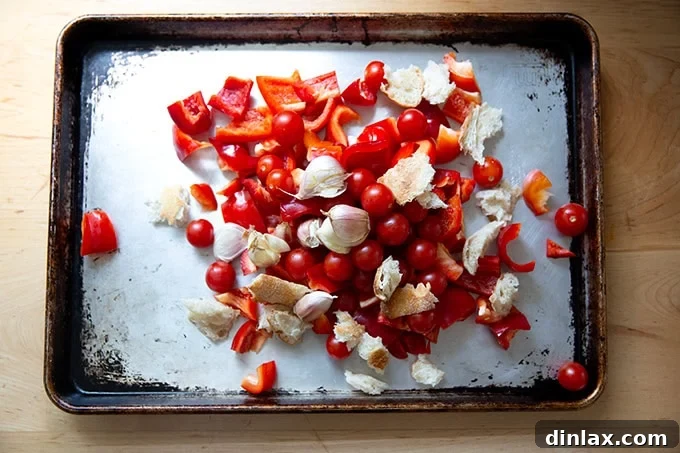 Zahmetsiz Romesco Sosu: Biberleri Soymaya Son! 5 Ingredients to make romesco sauce on a sheet pan.