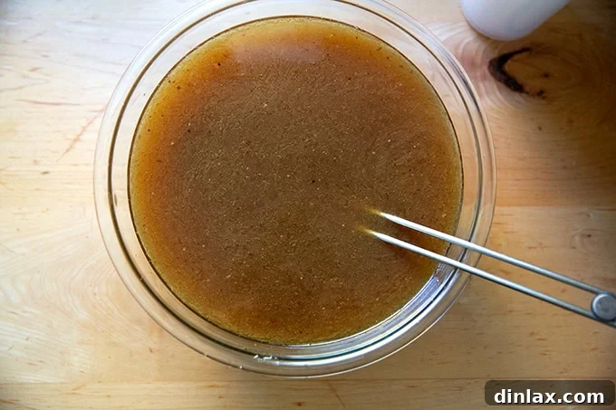 Make Ahead Roasted Turkey Wing Stock 19 A large bowl filled with the pure, golden liquid of freshly made turkey stock.