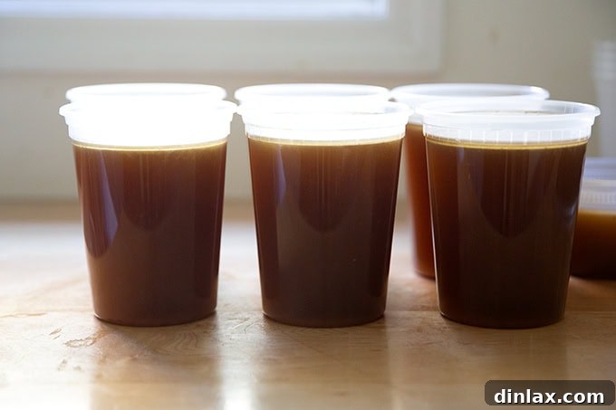 Make Ahead Roasted Turkey Wing Stock 21 Six quarts of rich, homemade turkey stock neatly lined up on a countertop, ready for final storage.