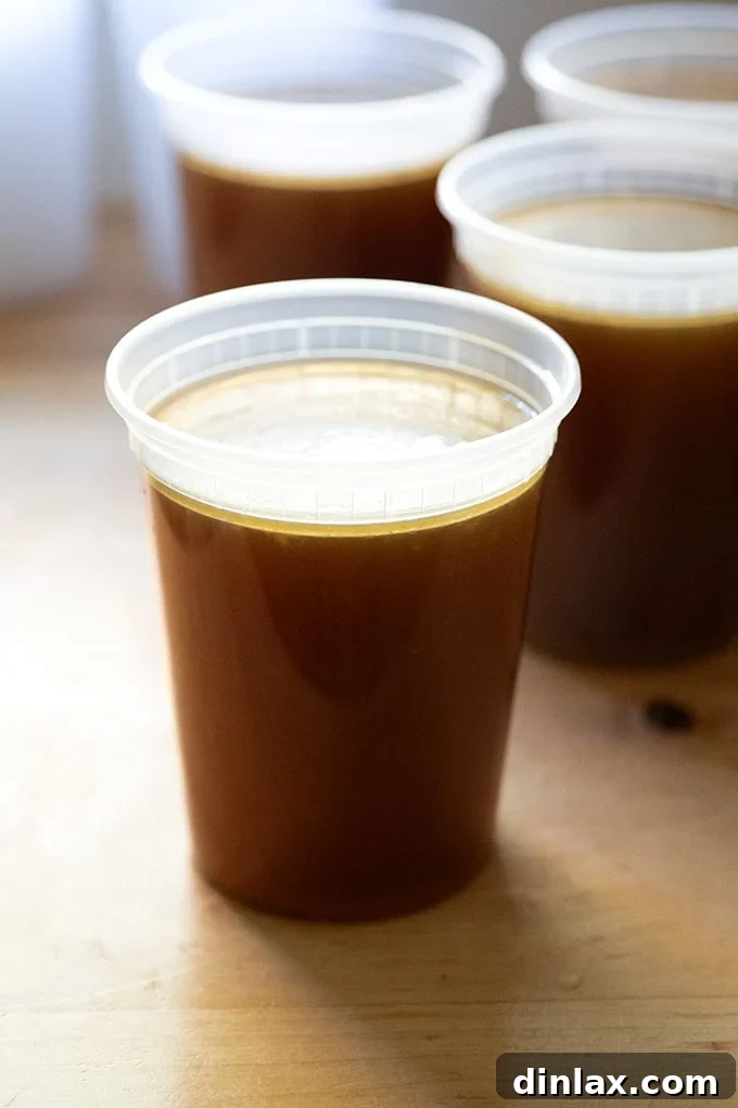 Make Ahead Roasted Turkey Wing Stock 23 A single quart of rich, golden turkey stock, showcasing its pristine clarity and inviting color.