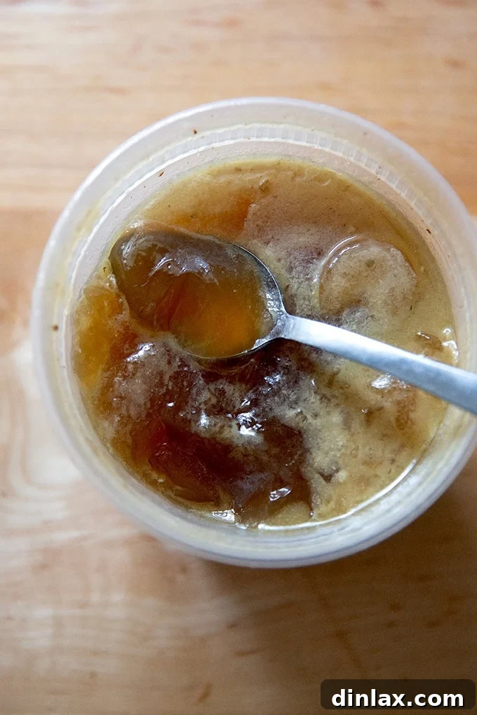 Make Ahead Roasted Turkey Wing Stock 24 A quart container of rich, jellied turkey stock, a testament to its high gelatin content and robust flavor, ready for use.