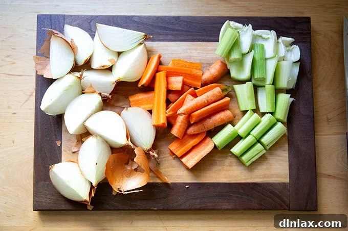 Make Ahead Roasted Turkey Wing Stock 7 A medley of freshly chopped vegetables — onions, carrots, and celery — neatly arranged on a cutting board, ready for the roasting pan.