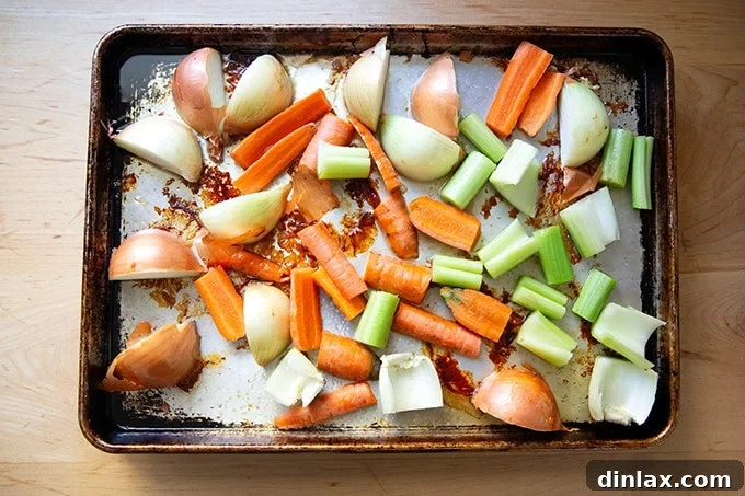 Make Ahead Roasted Turkey Wing Stock 8 Freshly chopped carrots, onions, and celery spread across a sheet pan, ready to be roasted alongside the turkey drippings.